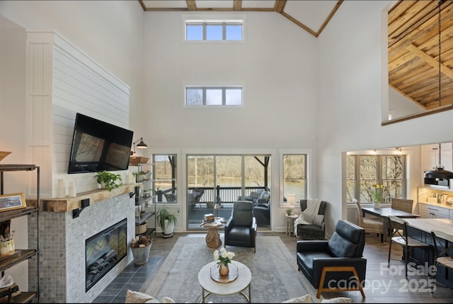 5888 Wood Duck Way, Catawba, NC 28609 - living room with high vaulted ceiling, a tiled fireplace, wood finished floors, and beamed ceiling