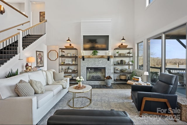 5888 Wood Duck Way, Catawba, NC 28609 - living area featuring a towering ceiling, plenty of natural light, wood finished floors, stairs, and a fireplace