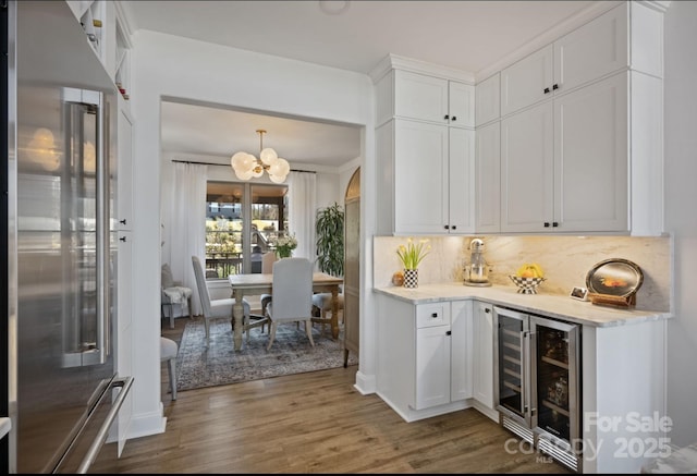 5888 Wood Duck Way, Catawba, NC 28609 - indoor dry bar with high end refrigerator, beverage cooler, a chandelier, wood finished floors, and decorative backsplash
