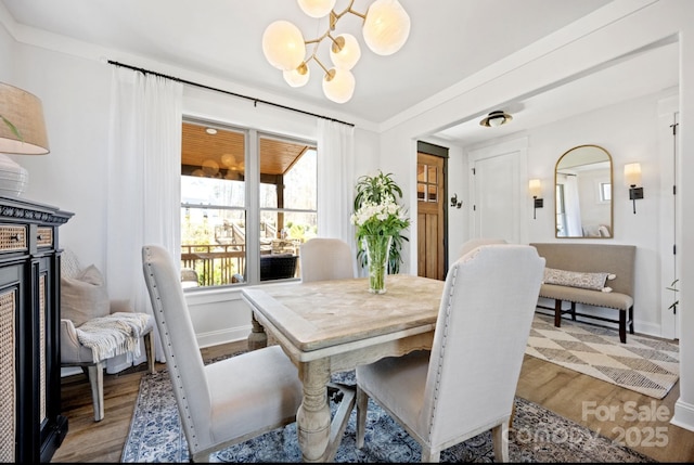 5888 Wood Duck Way, Catawba, NC 28609 - dining room featuring a chandelier, wood finished floors, and baseboards