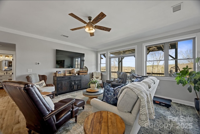 5888 Wood Duck Way, Catawba, NC 28609 - living area featuring a ceiling fan, wood finished floors, ornamental molding, and baseboards