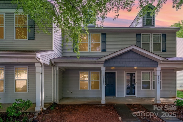 townhome / multi-family property featuring covered porch