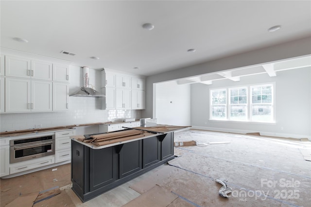 1504 Baileys Run, Gastonia, NC 28056 - kitchen with wall chimney exhaust hood, stainless steel oven, backsplash, white cabinetry, and a center island