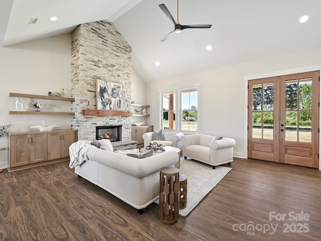 living room featuring high vaulted ceiling, a ceiling fan, dark wood-type flooring, and a fireplace