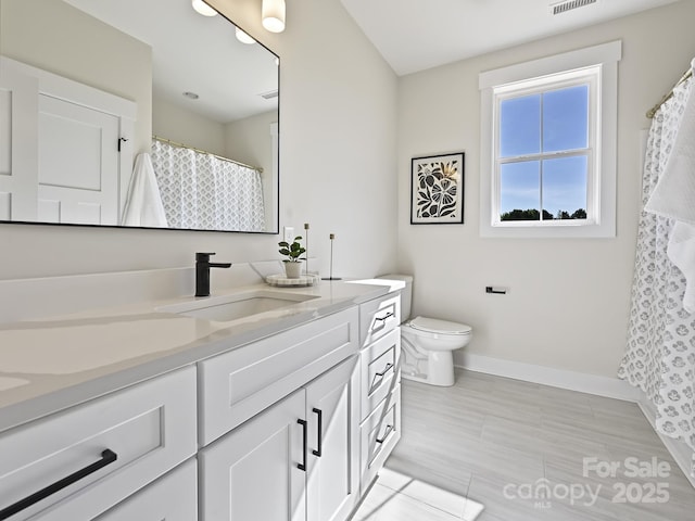 bathroom with tile patterned flooring, visible vents, toilet, vanity, and baseboards