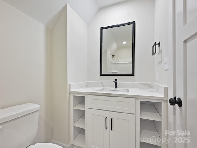 bathroom with baseboards, toilet, and vanity