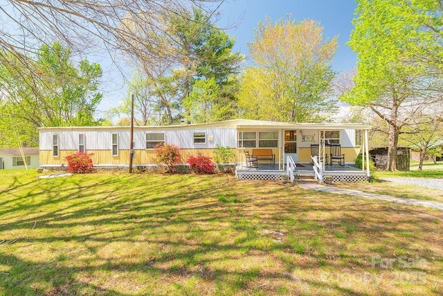 view of front of house with a porch and a front lawn