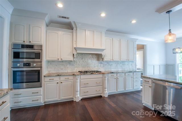 8810 Cool Meadow Dr, Huntersville, NC 28078 - kitchen with stainless steel appliances, light stone counters, white cabinets, recessed lighting, and a wainscoted wall