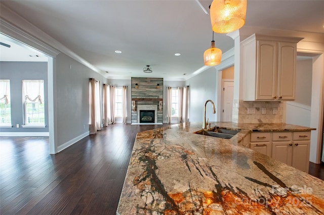 8810 Cool Meadow Dr, Huntersville, NC 28078 - kitchen featuring a sink, open floor plan, light stone counters, dark wood finished floors, and tasteful backsplash
