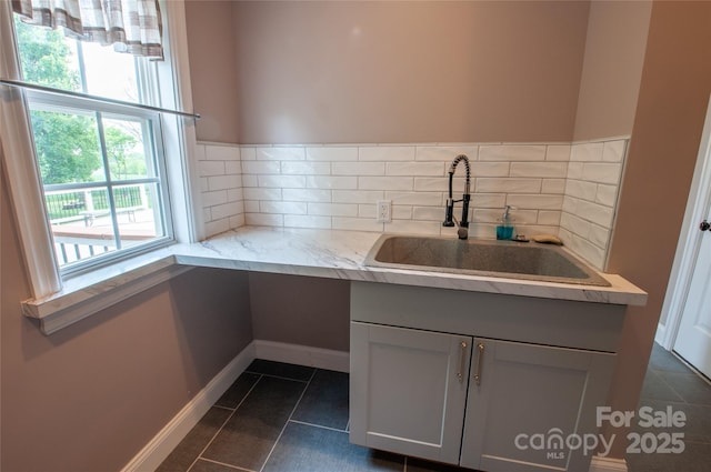 8810 Cool Meadow Dr, Huntersville, NC 28078 - kitchen with a sink, dark tile patterned floors, light stone countertops, and tasteful backsplash