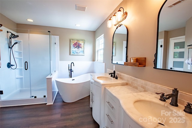 8810 Cool Meadow Dr, Huntersville, NC 28078 - bathroom with a stall shower, wood finished floors, a freestanding bath, vanity, and recessed lighting