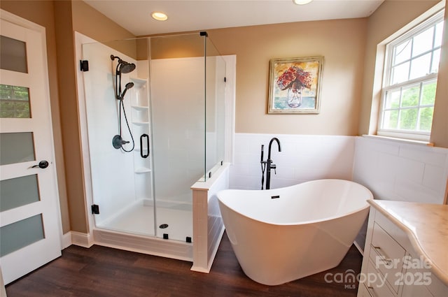 8810 Cool Meadow Dr, Huntersville, NC 28078 - bathroom with a stall shower, a freestanding bath, tile walls, wood finished floors, and recessed lighting