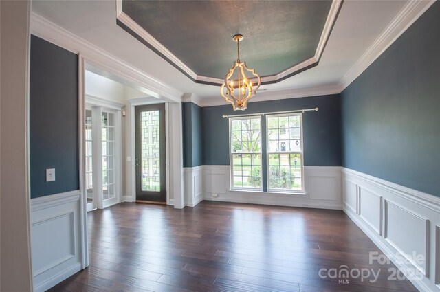 8810 Cool Meadow Dr, Huntersville, NC 28078 - unfurnished room with a tray ceiling, a chandelier, wainscoting, dark wood-type flooring, and ornamental molding