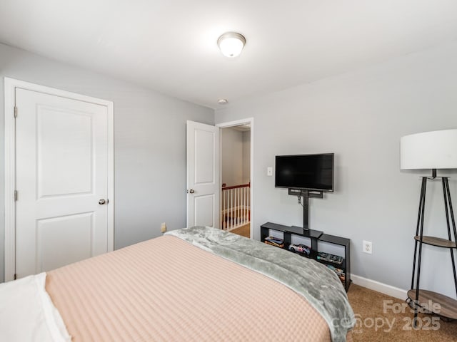 bedroom with baseboards and carpet floors