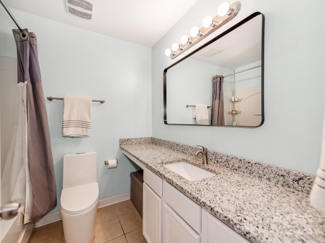 bathroom with vanity, baseboards, tile patterned flooring, toilet, and visible vents