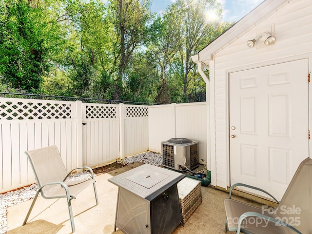 view of patio / terrace with central AC and a fenced backyard