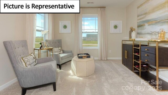sitting room featuring carpet flooring, visible vents, and baseboards