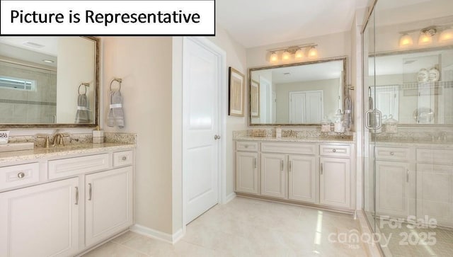 bathroom with a sink, two vanities, and a stall shower