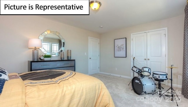 carpeted bedroom featuring a closet and baseboards