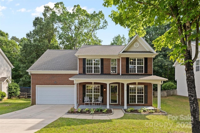 view of front of house with brick siding, fence, covered porch, and a front yard
