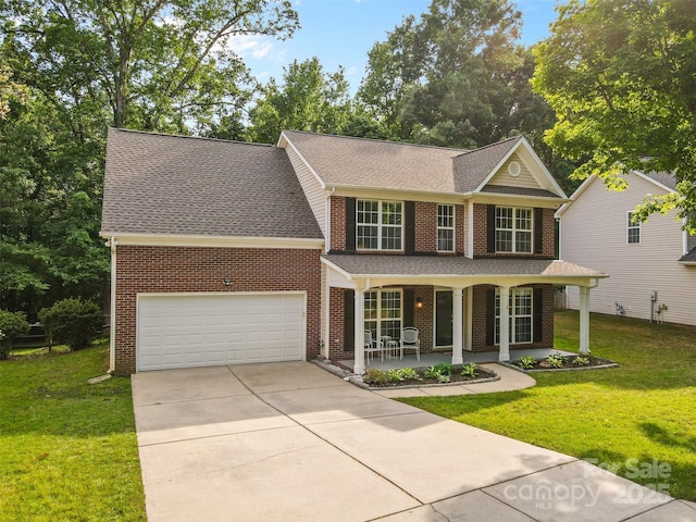 view of front of home with a porch, driveway, a front yard, a garage, and brick siding