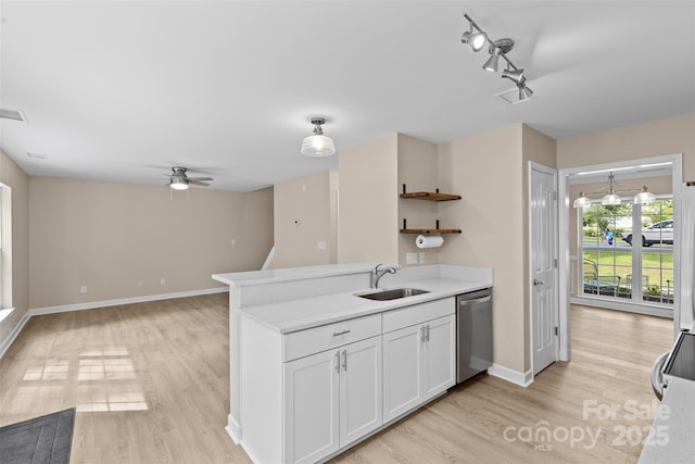 kitchen featuring light wood-type flooring, a sink, ceiling fan, and dishwasher