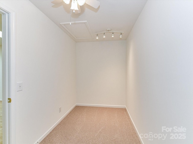 11705 Silverado Ln, Charlotte, NC 28277 - empty room featuring light carpet, ceiling fan, baseboards, and rail lighting