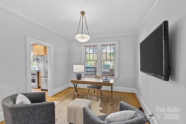 office featuring light wood-style floors, baseboards, and crown molding