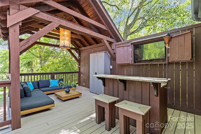 wooden terrace featuring outdoor lounge area