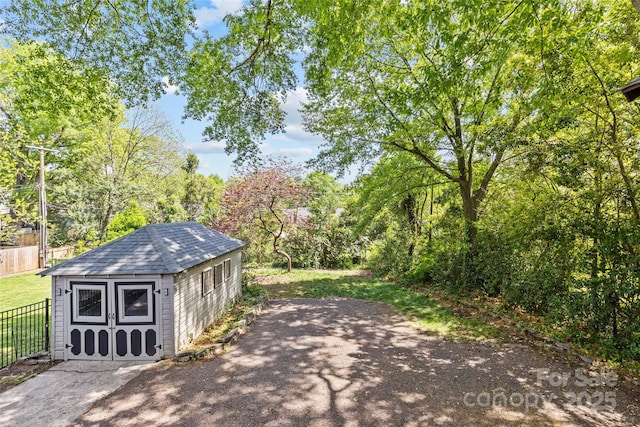 view of shed featuring fence