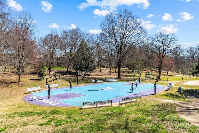 surrounding community with community basketball court and a lawn