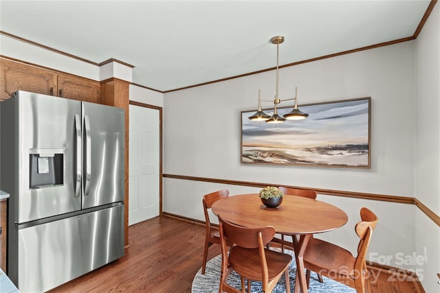 dining room with dark wood-style flooring and ornamental molding