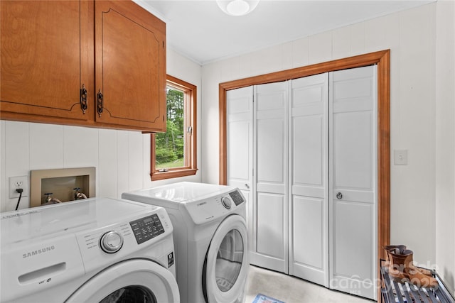 washroom with cabinet space and washer and clothes dryer