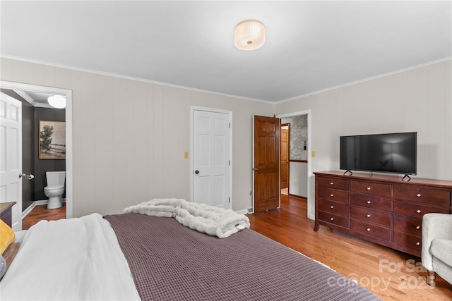 bedroom with ornamental molding, ensuite bath, and light wood-style floors