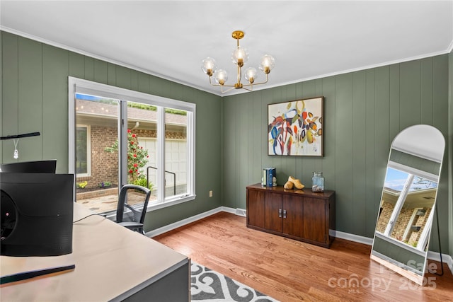 office featuring a chandelier, baseboards, ornamental molding, and light wood-style floors