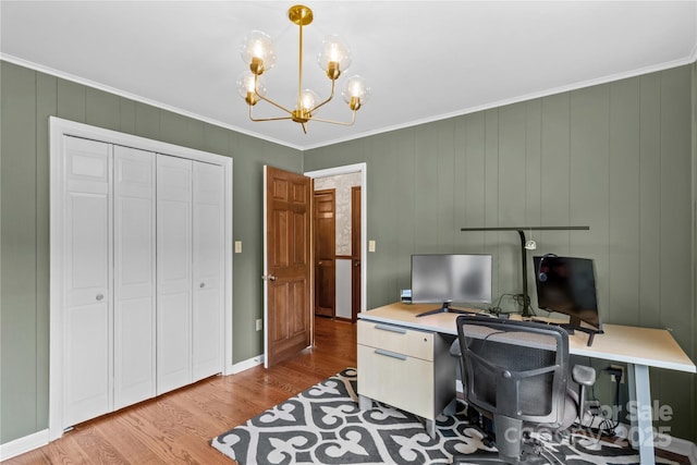 home office with a chandelier, wood finished floors, and crown molding