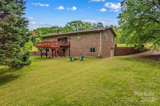 back of property featuring a chimney, stairway, brick siding, a garage, and a wooden deck