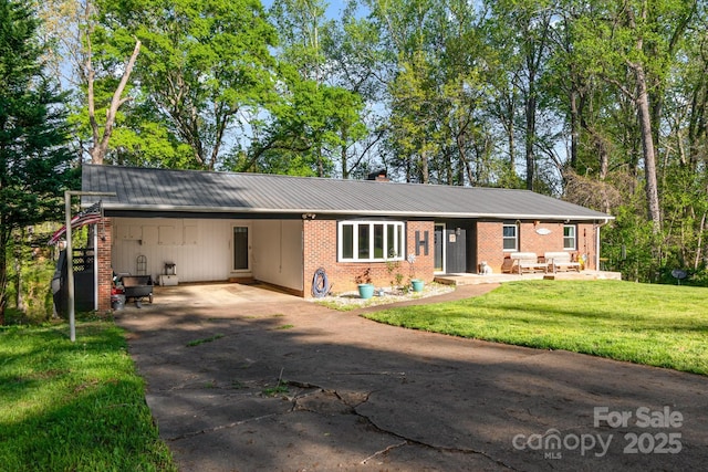 1218 Donna Dr, Shelby, NC 28152 - ranch-style house featuring a carport, driveway, a front lawn, and brick siding