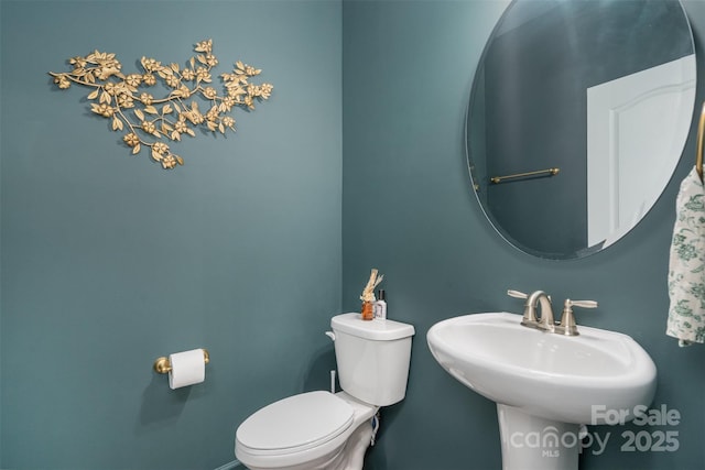 bathroom with toilet and a sink
