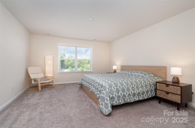 carpeted bedroom featuring baseboards