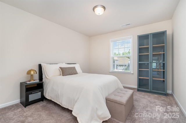 bedroom featuring visible vents, baseboards, and carpet flooring