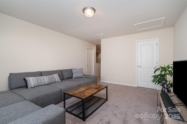 living area with carpet, visible vents, baseboards, and attic access