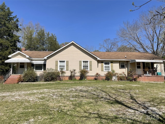 view of front of house with a front lawn, a porch, and a shingled roof
