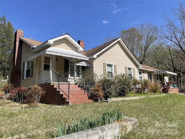view of front of home with a chimney and a front yard