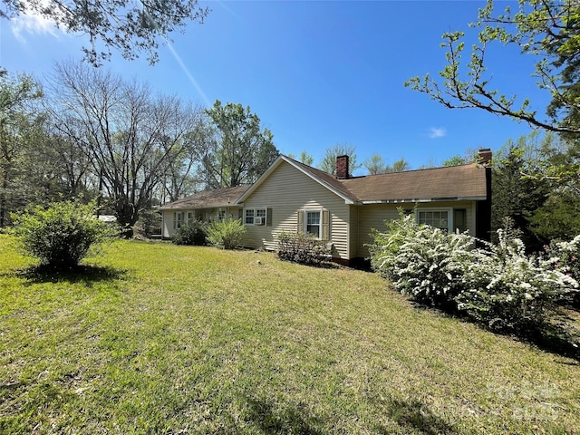 view of home's exterior with a lawn