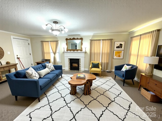 carpeted living room featuring a fireplace with flush hearth, a textured ceiling, baseboards, and ornamental molding