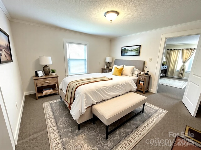 bedroom featuring baseboards, ornamental molding, and dark colored carpet