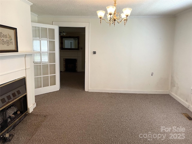 215 Old Dixie Rd, Lancaster, SC 29720 - unfurnished living room featuring a fireplace, carpet, a chandelier, ornamental molding, and a textured ceiling