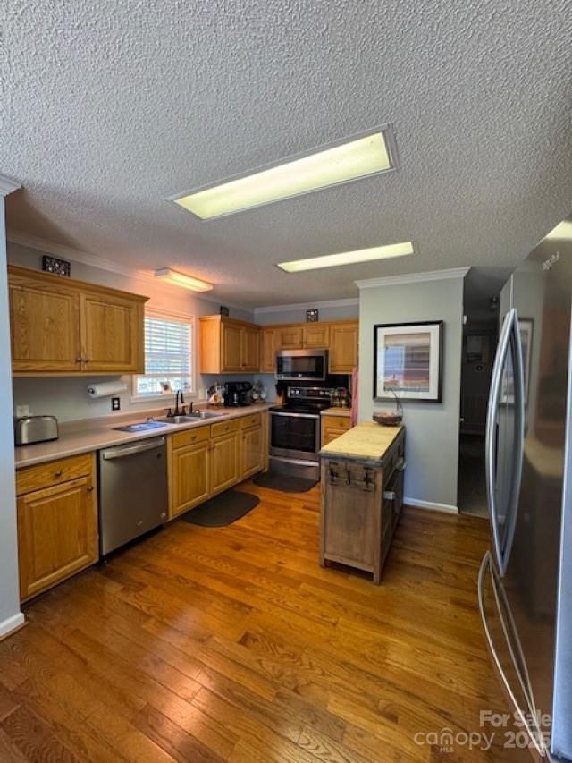 1273 Wateree Estates Rd, Winnsboro, SC 29180 - kitchen with dark wood-type flooring, appliances with stainless steel finishes, a sink, and light countertops