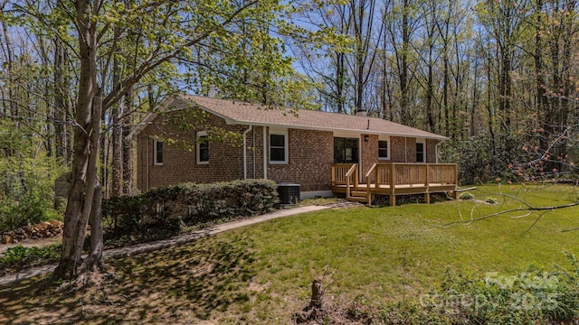 280 Fletcher View Dr, Fletcher, NC 28732 - rear view of house featuring a wooden deck, brick siding, a yard, a chimney, and cooling unit
